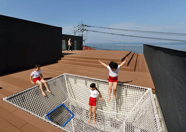 kids jumping on a trampoline at a new school design for lunch lady magazine