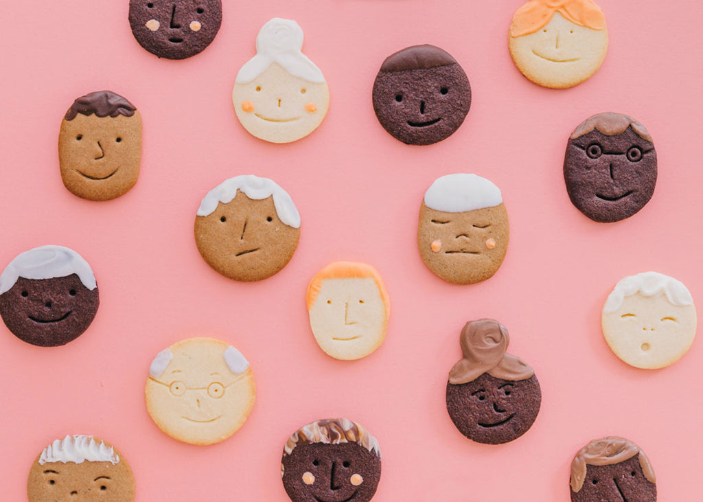 Photos of biscuits that look like faces with chocolate and icing hair styles