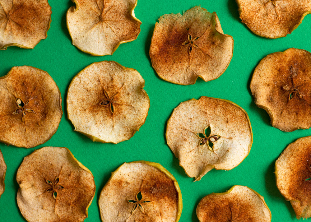 baked apple chips on a green background for Lunch Lady Magazine