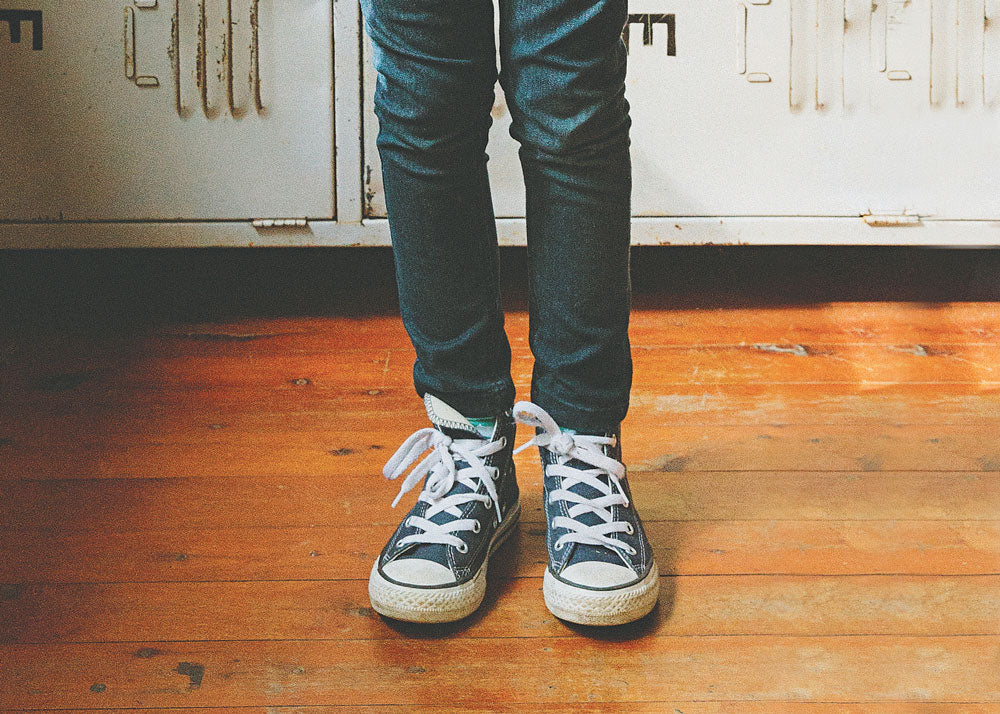 photo of converse hi tops on a child's legs for Lunch Lady Magazine