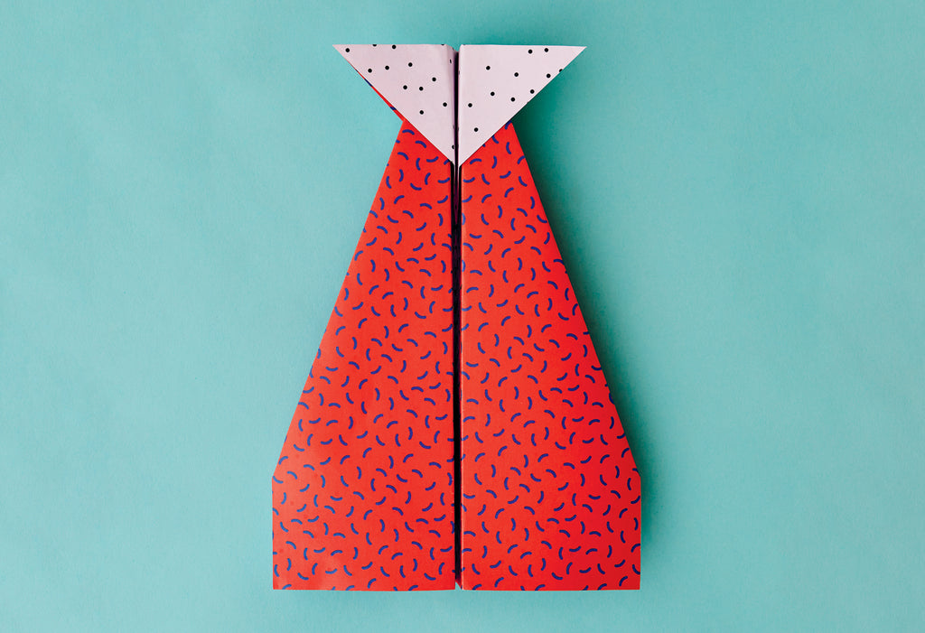 Photo of red paper aeroplane for bored children. Instructions on how to make a fast paper plane.