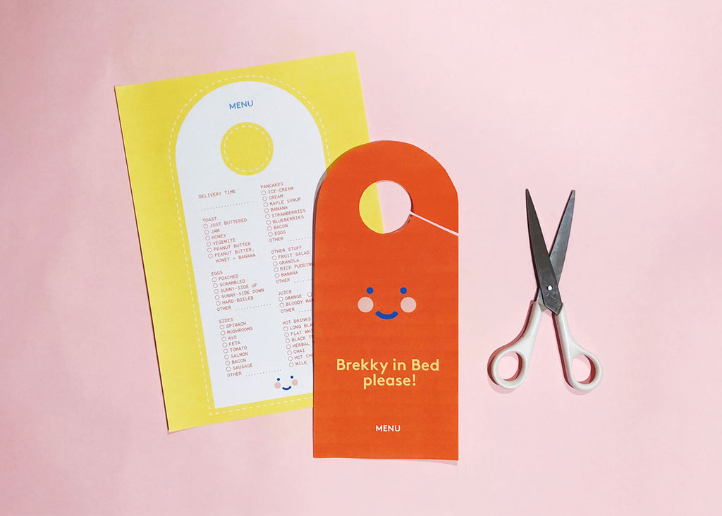 Photo of a printable DIY door hanger menu for Lunch Lady Magazine with scissors beside it