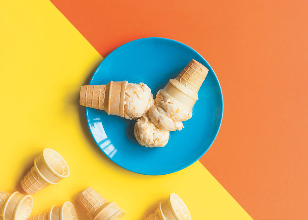photo of homemade apricot ice cream in cones on a blue plate for lunch lady magazine