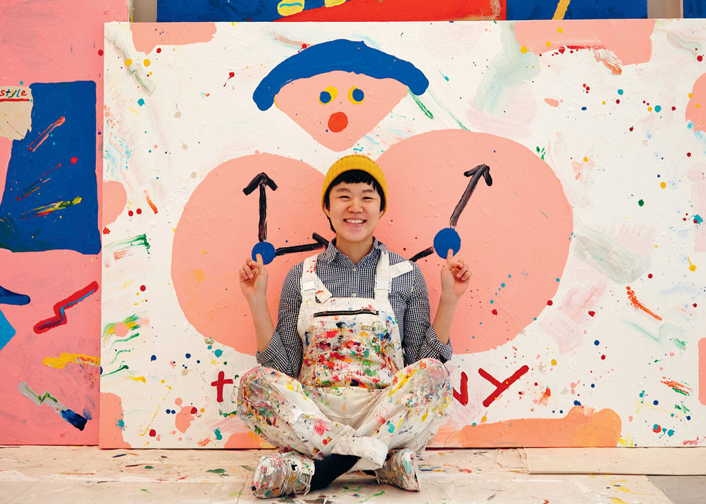 Misaki Kawai sits in front of a painting for Lunch Lady Magazine