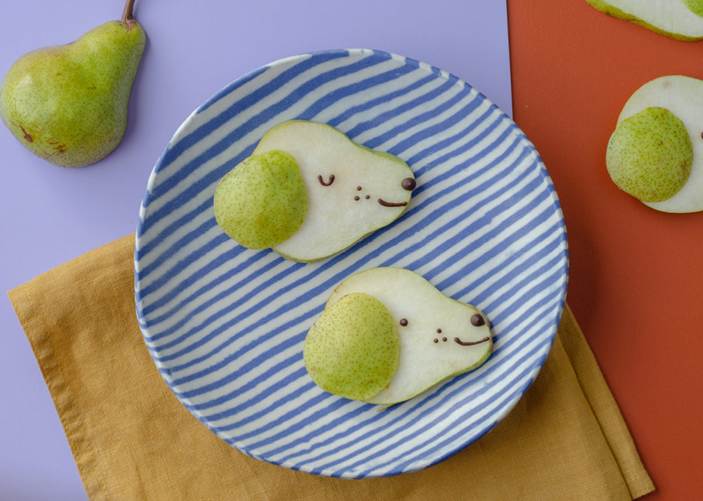 cute food idea: sliced pears made to look like puppy faces for Lunch Lady Magazine