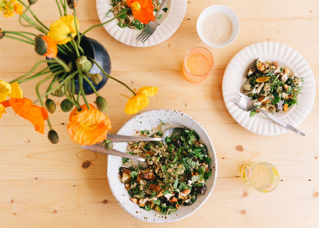 herbed quinoa salad in bowls on a table with poppies in a vase for lunch lady magazine