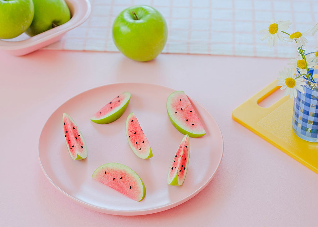 trick food: a plate of apple slices decorated to look like mini watermelon pieces